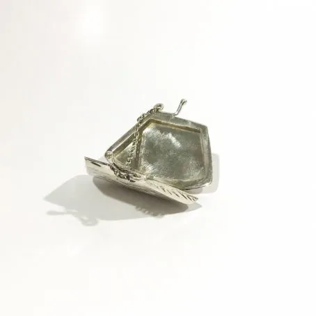 vintage silver pad holder in the shape of an open handbag