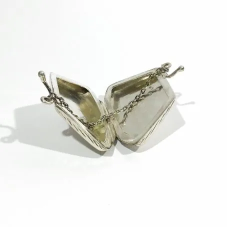 vintage silver pillbox in the shape of an open handbag