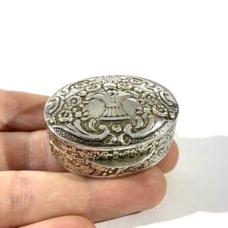 italian solid silver pill box, hallmarked  with embossed floral decorations