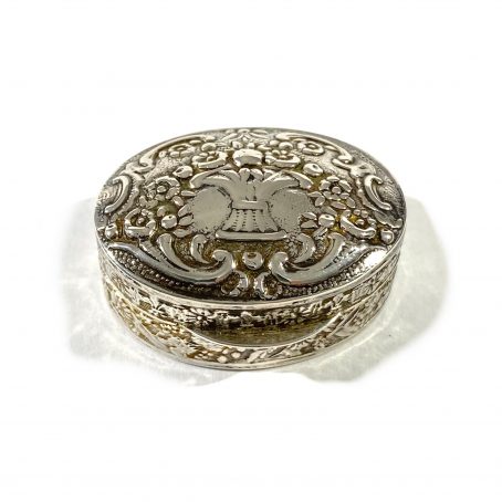 italian solid silver pill box, hallmarked  with embossed floral decorations